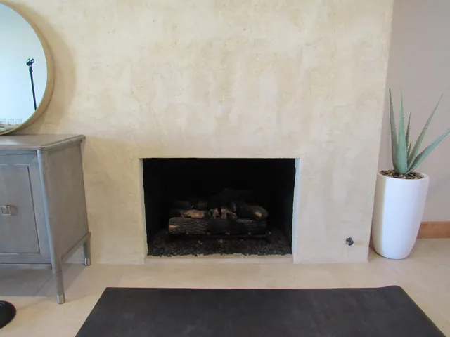 a living room with furniture a window and a fireplace