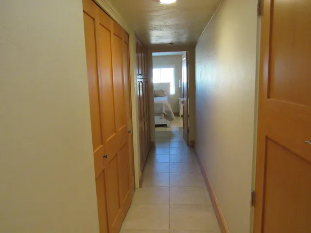 a bathroom with a granite countertop toilet sink and mirror