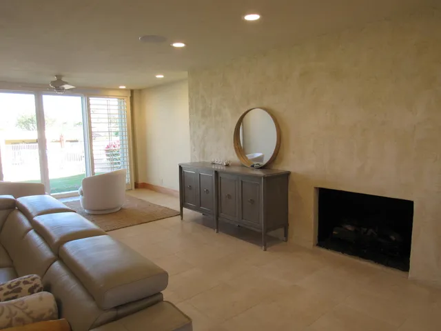 a bedroom with a bed and a flat tv screen on dresser