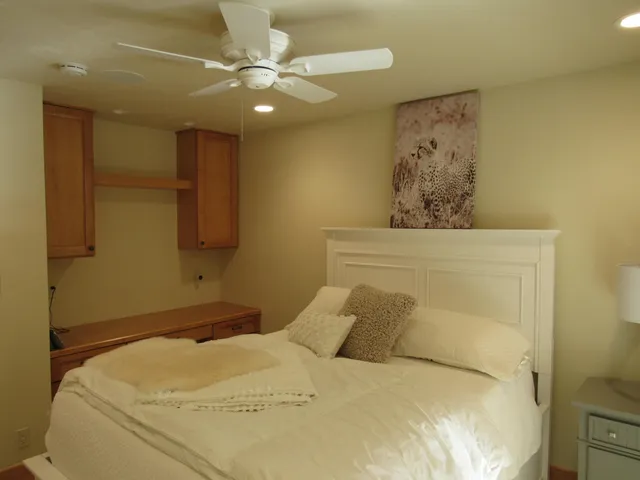 a bedroom with a bed and a chandelier