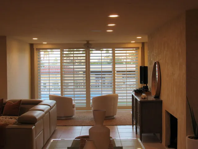 a living room with furniture and a floor to ceiling window