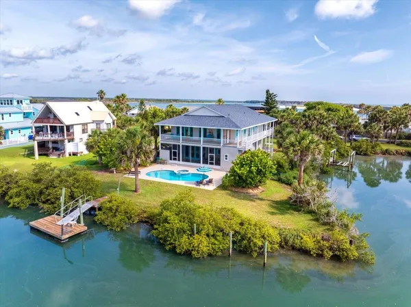 a view of a swimming pool and lounge chairs in the terrace