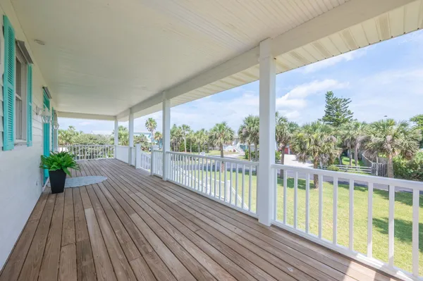 a view of a balcony with wooden floor