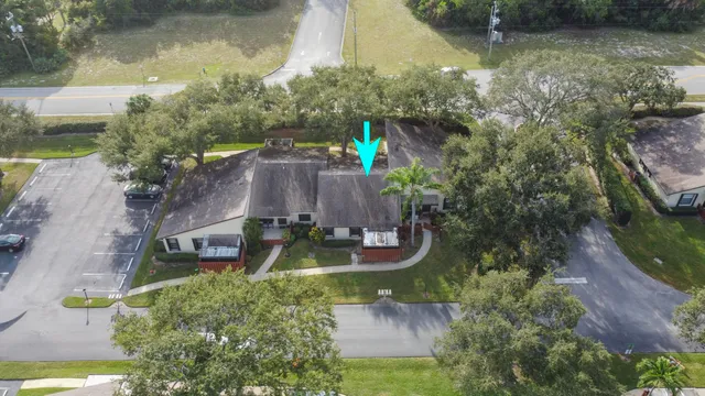 an aerial view of a house with outdoor space tennis courts and ocean view