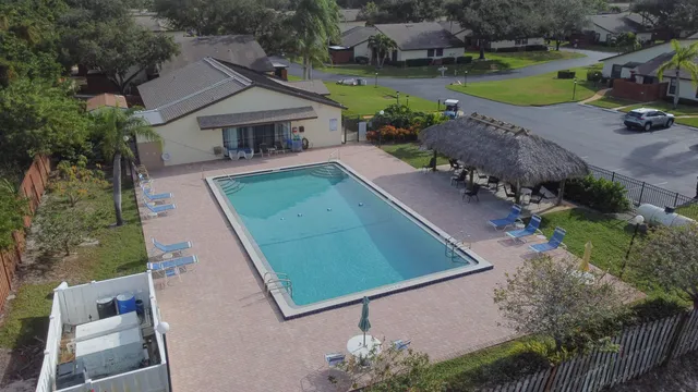 an aerial view of a house with a garden and lake view