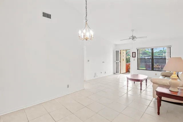 a view of a livingroom with a chandelier furniture and windows