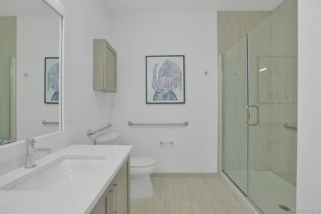 a bathroom with a double vanity sink toilet and a mirror