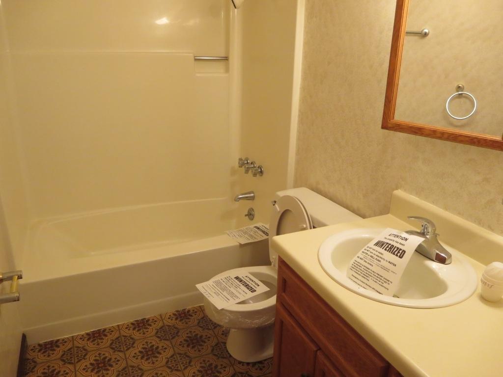1914 Navigation Point Goodview, VA 24095 - Photo 7 of 15 a bathroom with a sink a toilet and a bathtub