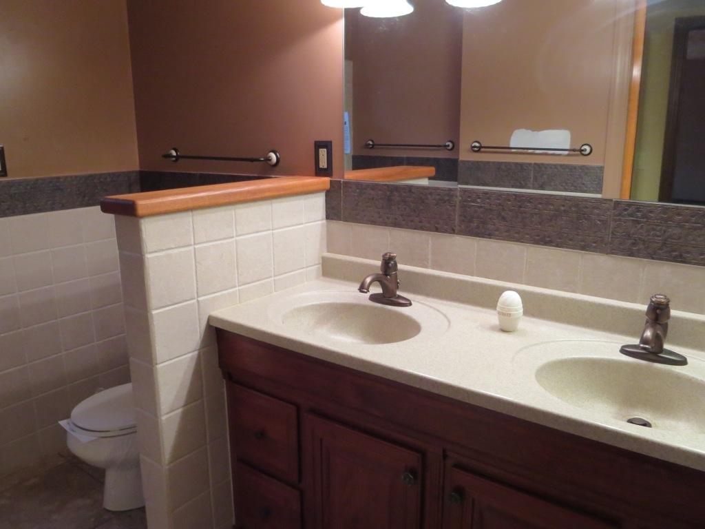 1914 Navigation Point Goodview, VA 24095 - Photo 10 of 15 a bathroom with a double vanity sink toilet and a mirror