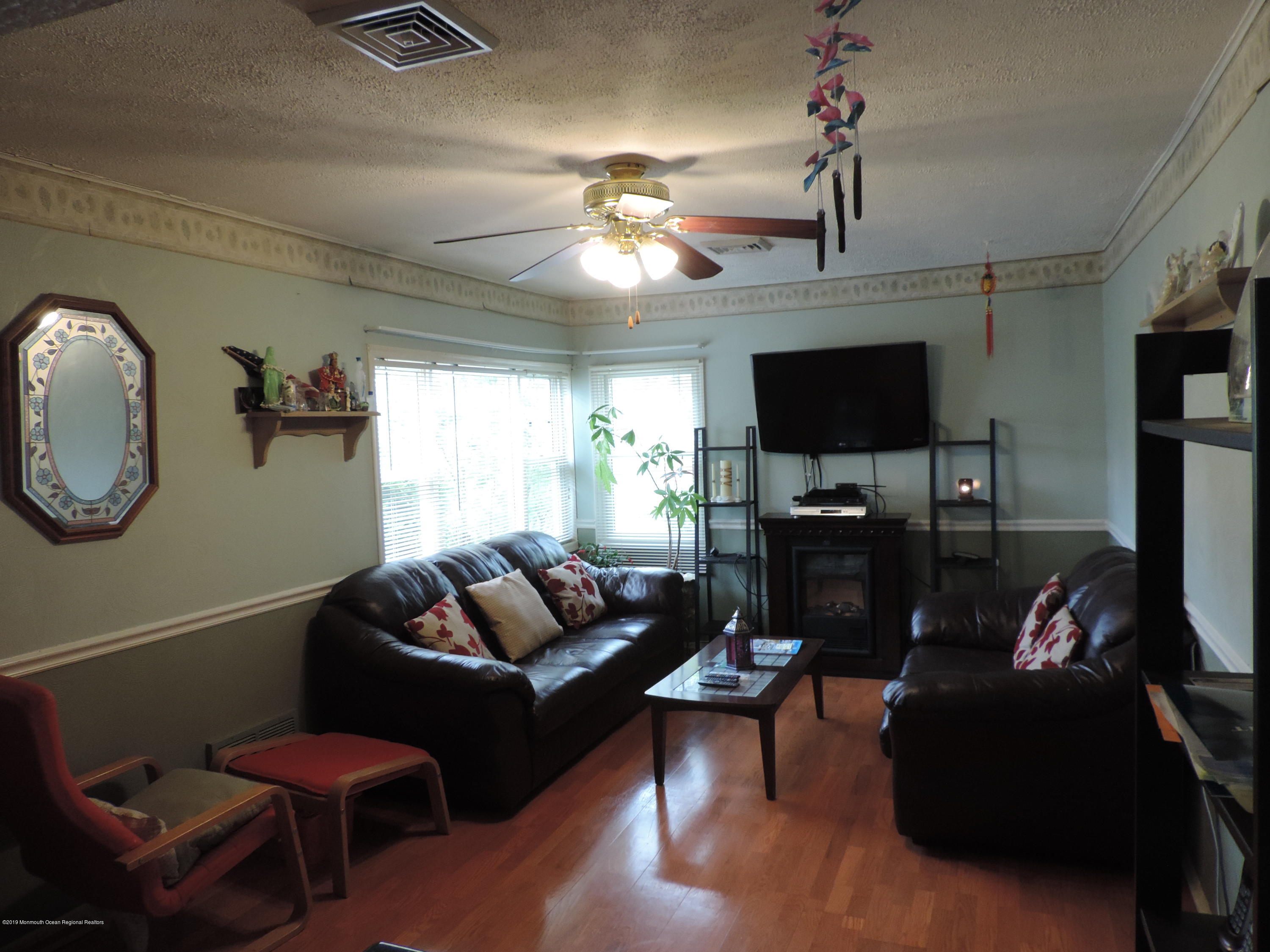 145 Breton Road Brick, NJ 08723 - Photo 8 of 33 a living room with furniture a ceiling fan and a flat screen tv