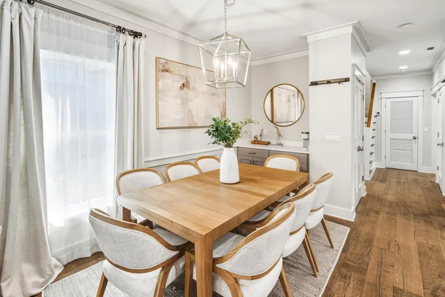 a spacious bedroom with a bed and wooden floor