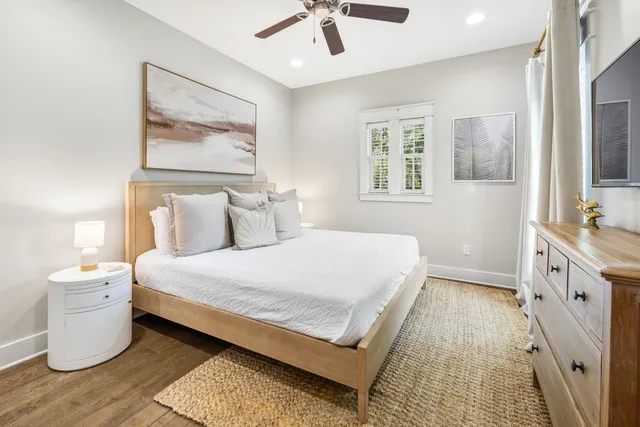 a spacious bedroom with a double vanity sink and a mirror