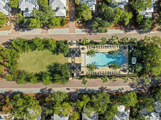 a view of a swimming pool with sitting area and garden