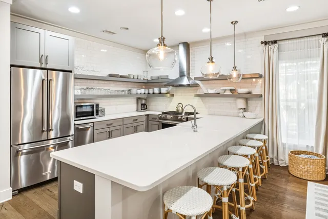 a view of a kitchen counter space a sink wooden floor and furniture