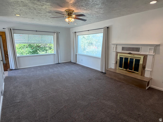 151 South Roosevelt Helper, UT 84526 - Photo 3 of 20 Spacious living area featuring a fireplace with a white mantel and brass-accented doors
