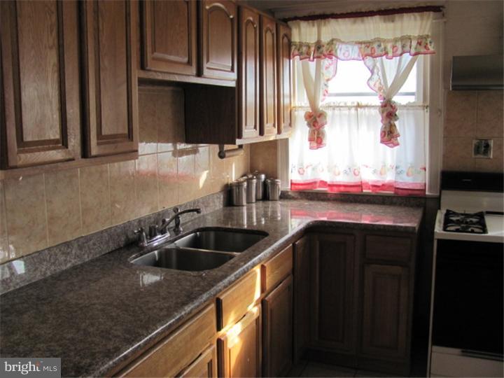 227 Copley Road Upper Darby, PA 19082 - Photo 5 of 8 a kitchen with a sink cabinets and window