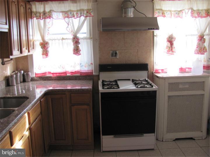 227 Copley Road Upper Darby, PA 19082 - Photo 6 of 8 a kitchen with stainless steel appliances granite countertop a stove and a microwave