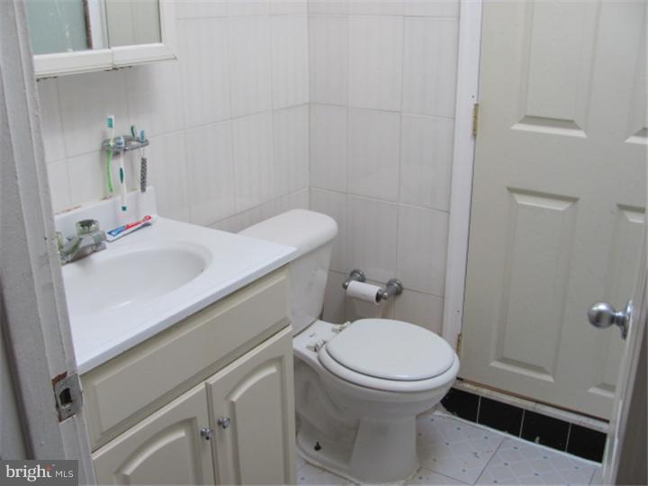 227 Copley Road Upper Darby, PA 19082 - Photo 8 of 8 a bathroom with a sink and a toilet