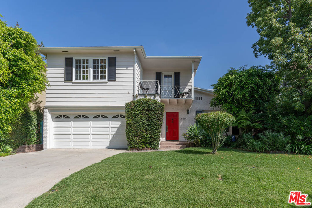 620 North Cherokee Avenue Los Angeles, CA 90004 - Photo 1 of 64 a front view of a house with a garden