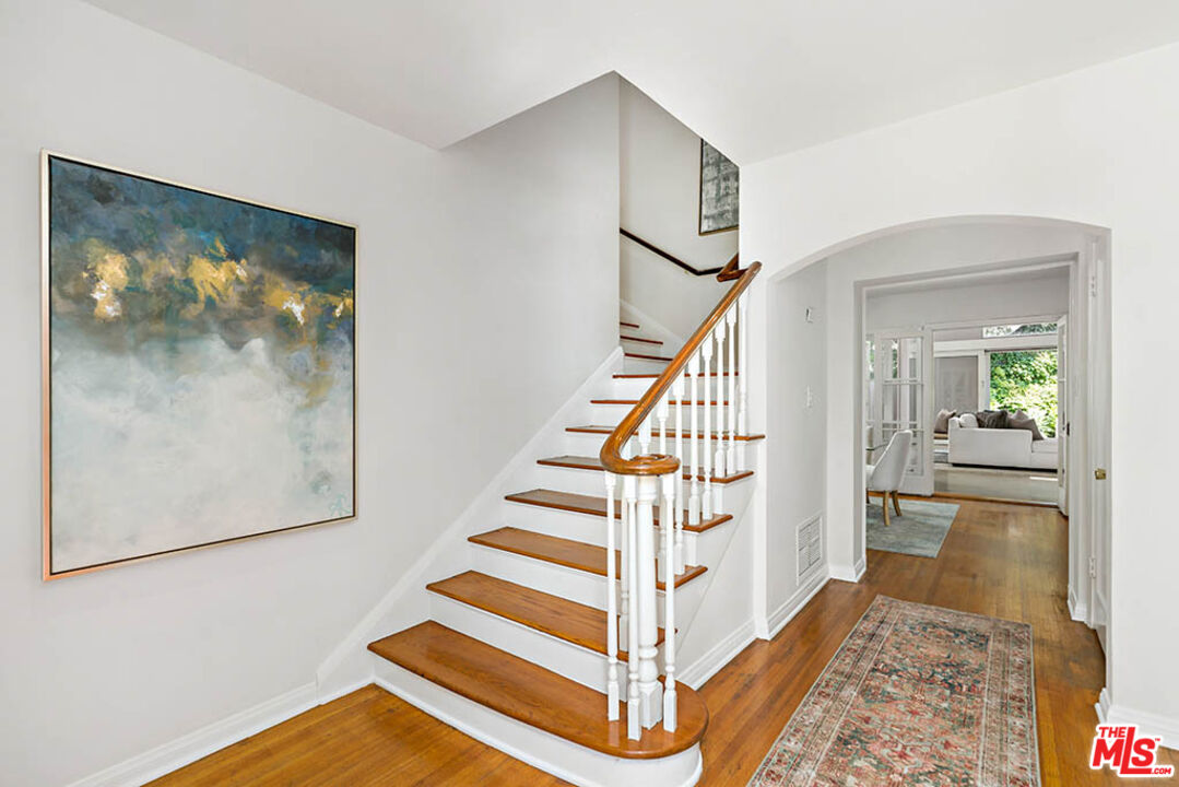 620 North Cherokee Avenue Los Angeles, CA 90004 - Photo 12 of 64 a view of staircase with wooden floor and a rug