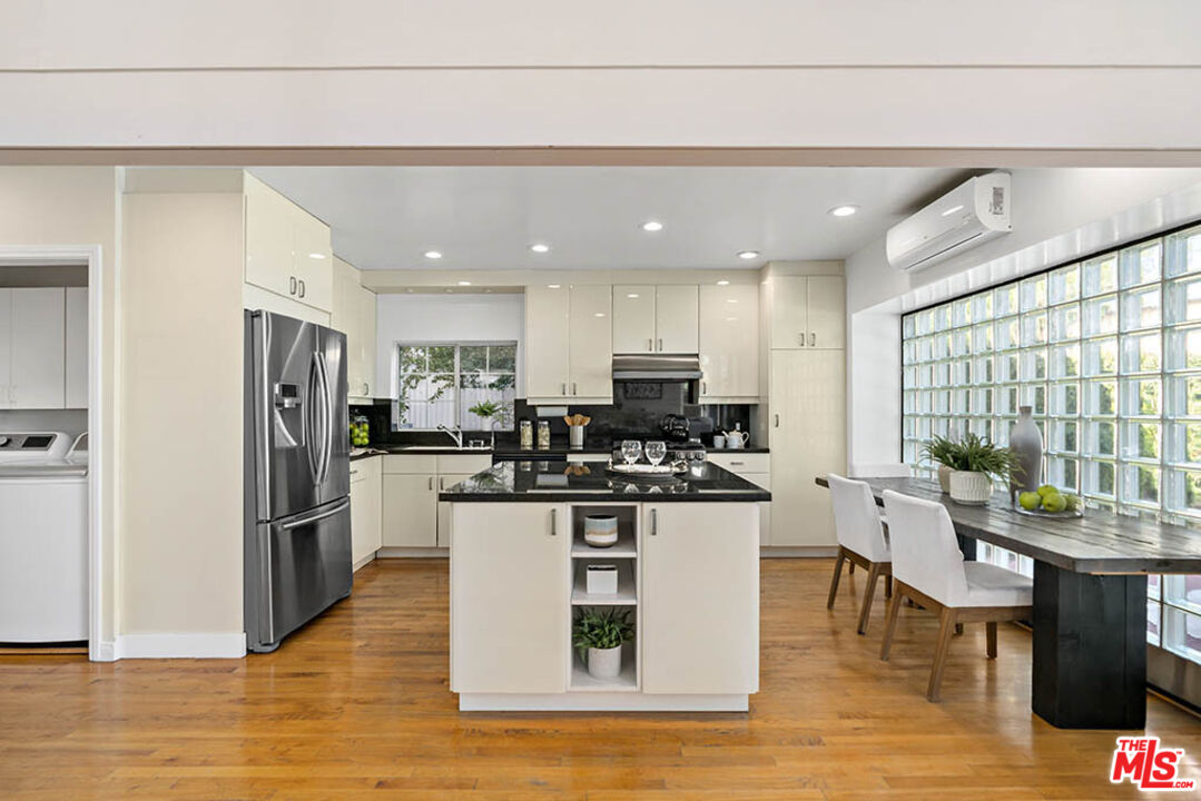 620 North Cherokee Avenue Los Angeles, CA 90004 - Photo 26 of 64 a kitchen with stainless steel appliances kitchen island granite countertop a refrigerator and a stove top oven