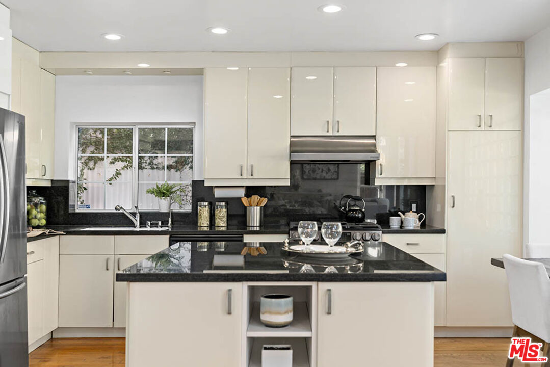 620 North Cherokee Avenue Los Angeles, CA 90004 - Photo 27 of 64 a kitchen with stainless steel appliances granite countertop a sink and a stove