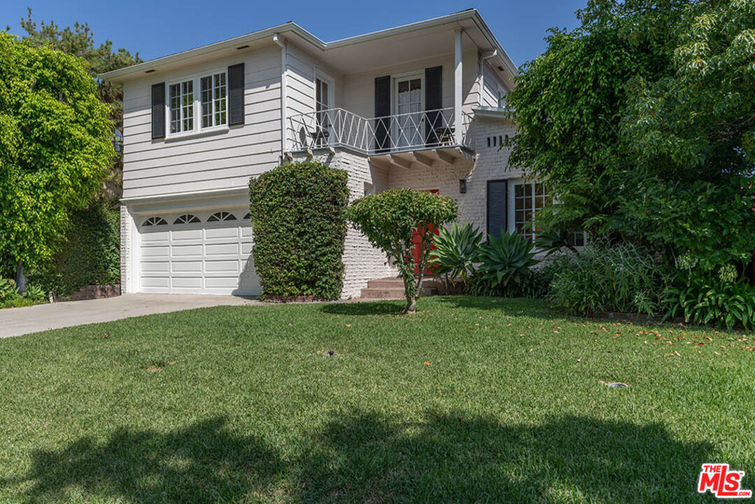620 North Cherokee Avenue Los Angeles, CA 90004 - Photo 3 of 64 a front view of a house with a garden