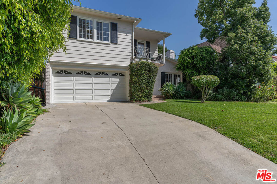620 North Cherokee Avenue Los Angeles, CA 90004 - Photo 4 of 64 a front view of a house with a yard and garage