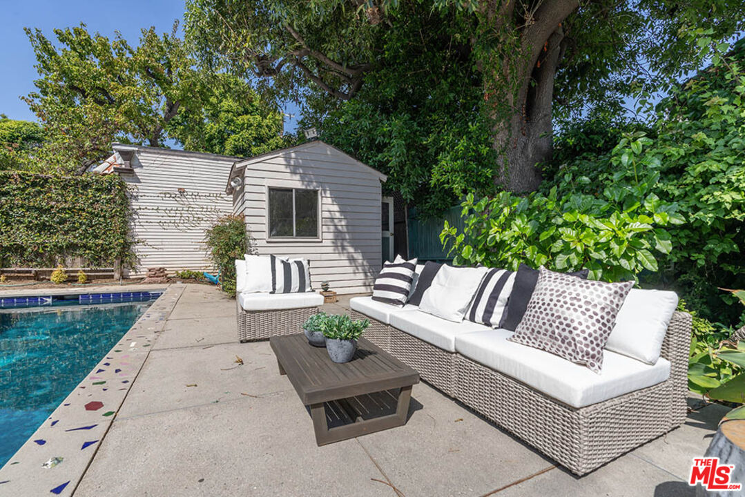 620 North Cherokee Avenue Los Angeles, CA 90004 - Photo 58 of 64 a view of a patio with couches table and chairs with plants and trees