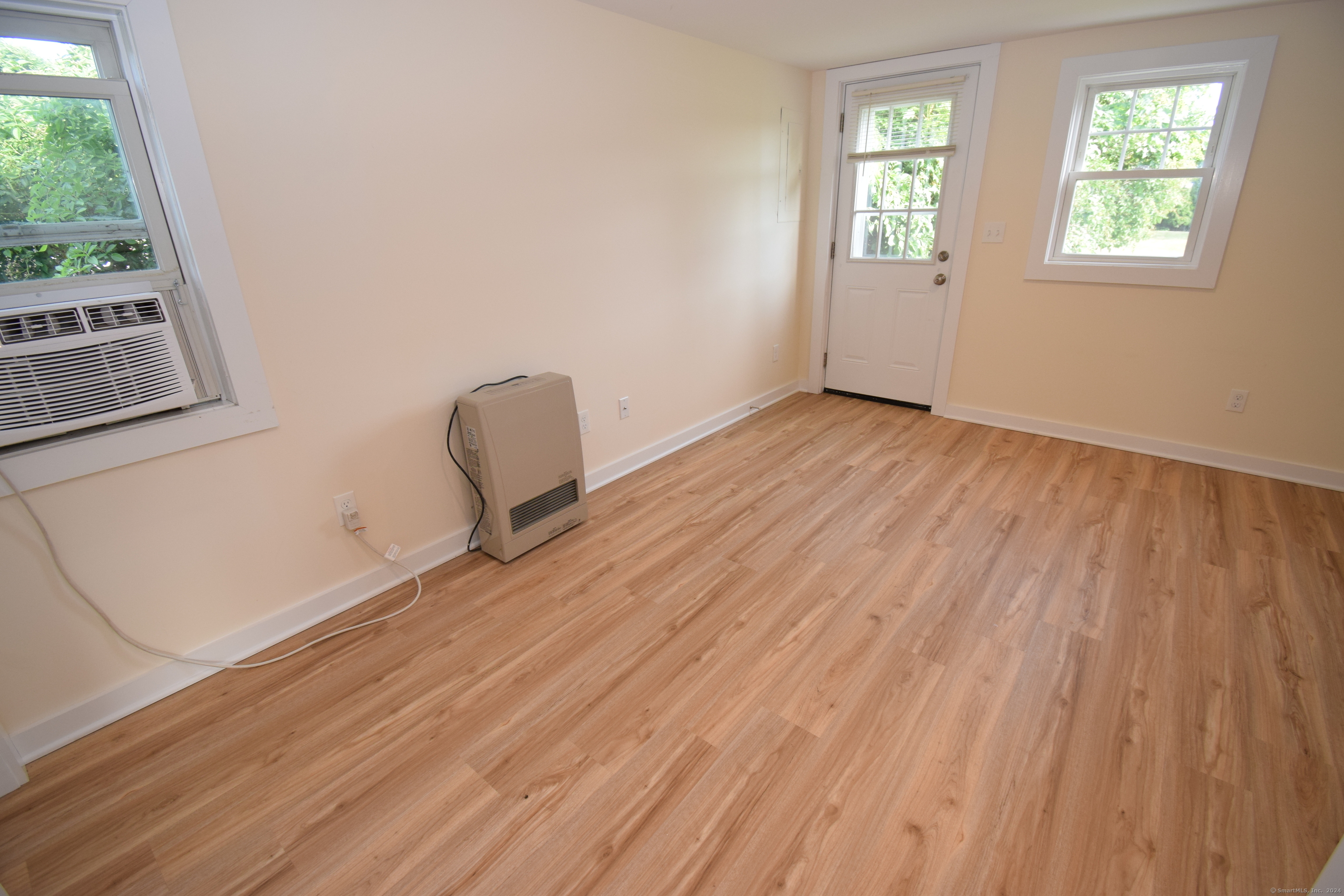 37 Dudley Lane, Unit 6 Madison, CT 06443 - Photo 3 of 12 a view of a room with wooden floor and chair