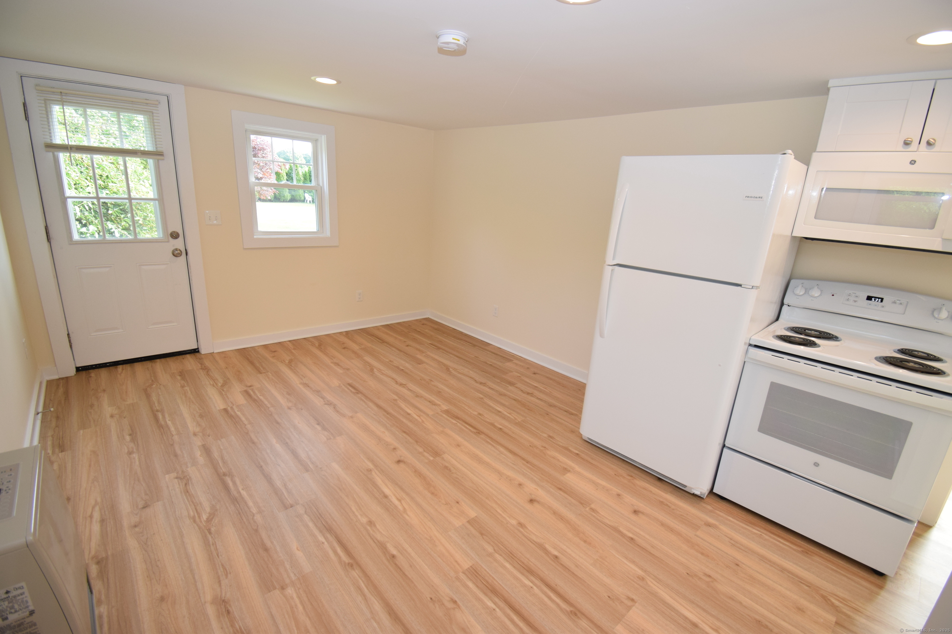 37 Dudley Lane, Unit 6 Madison, CT 06443 - Photo 5 of 12 a view of a kitchen with wooden floor and electronic appliances