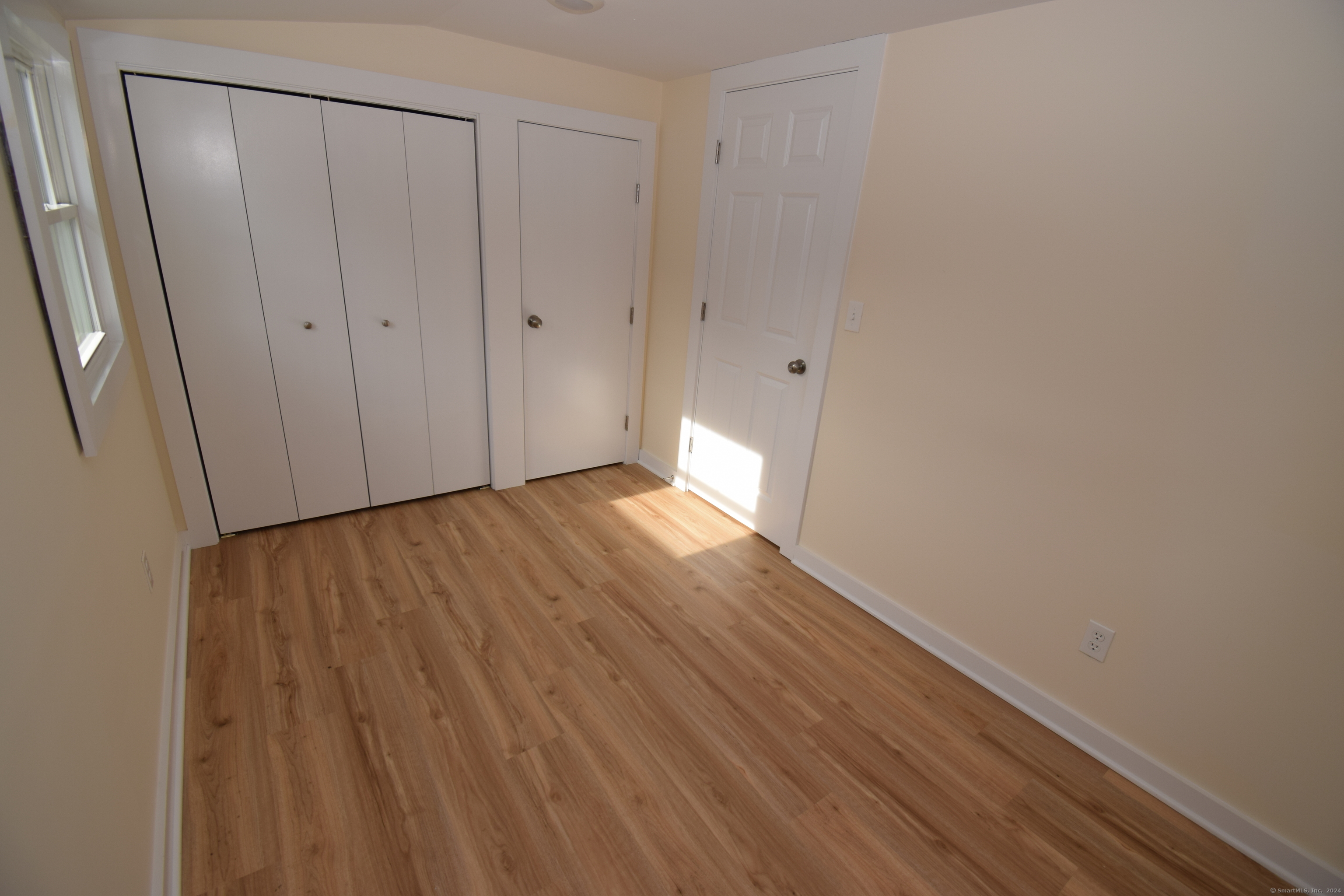 37 Dudley Lane, Unit 6 Madison, CT 06443 - Photo 8 of 12 a view of an empty room with wooden floor