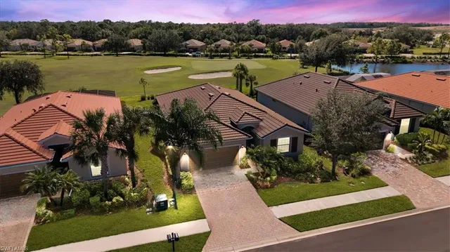 an aerial view of a house with garden space and lake view