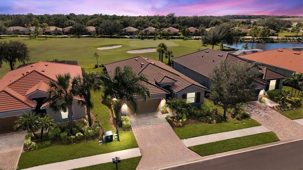 an aerial view of a house with garden space and lake view