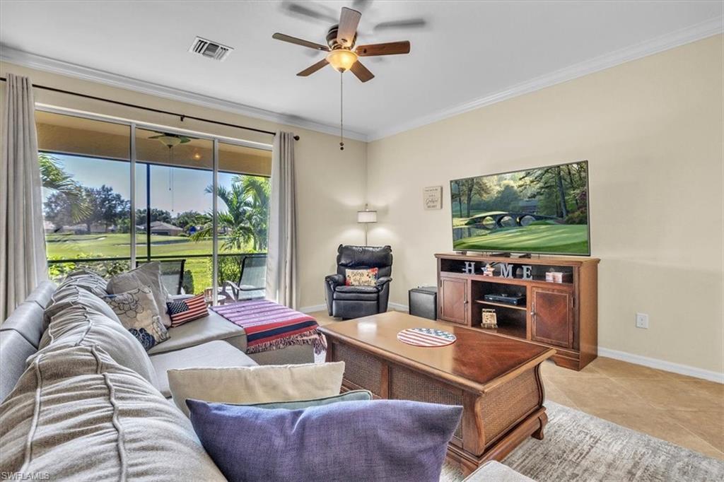 3112 Walnut Grove Lane Alva, FL 33920 - Photo 11 of 50 a living room with furniture a floor to ceiling window and a flat screen tv