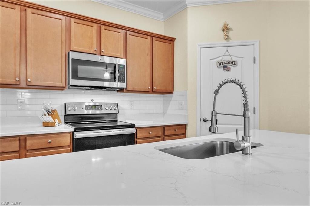 3112 Walnut Grove Lane Alva, FL 33920 - Photo 14 of 50 a kitchen with stainless steel appliances granite countertop a stove a sink and a microwave