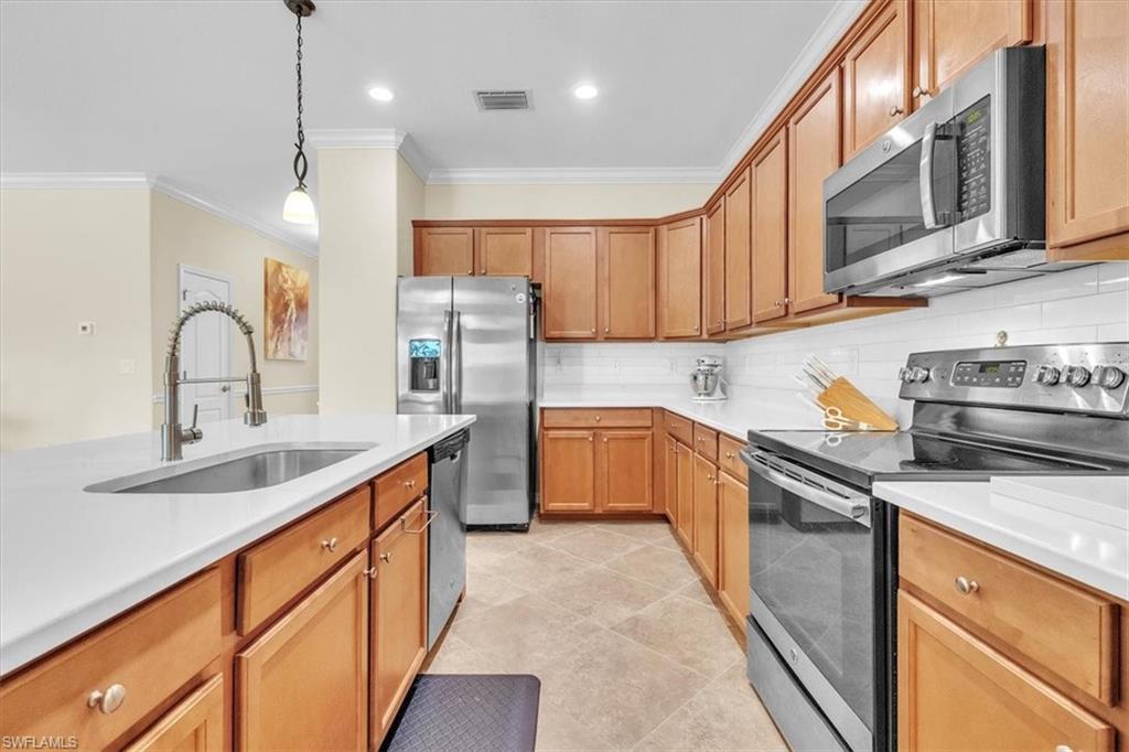 3112 Walnut Grove Lane Alva, FL 33920 - Photo 16 of 50 a kitchen with stainless steel appliances granite countertop a sink a stove and a refrigerator