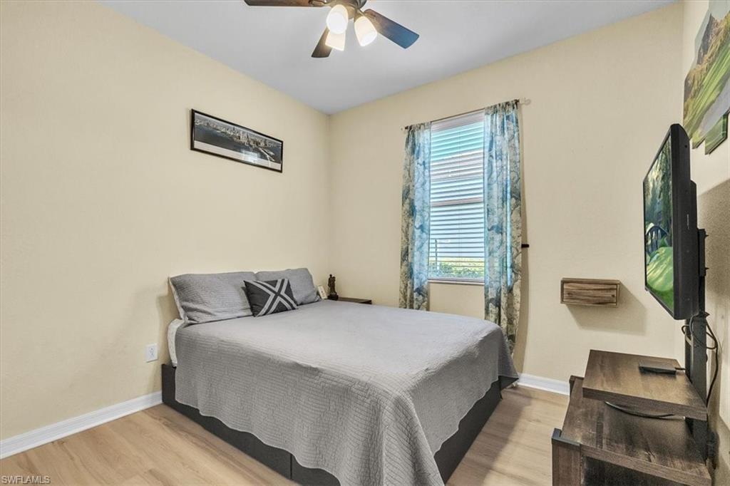 3112 Walnut Grove Lane Alva, FL 33920 - Photo 23 of 50 a bedroom with a bed and a flat screen tv