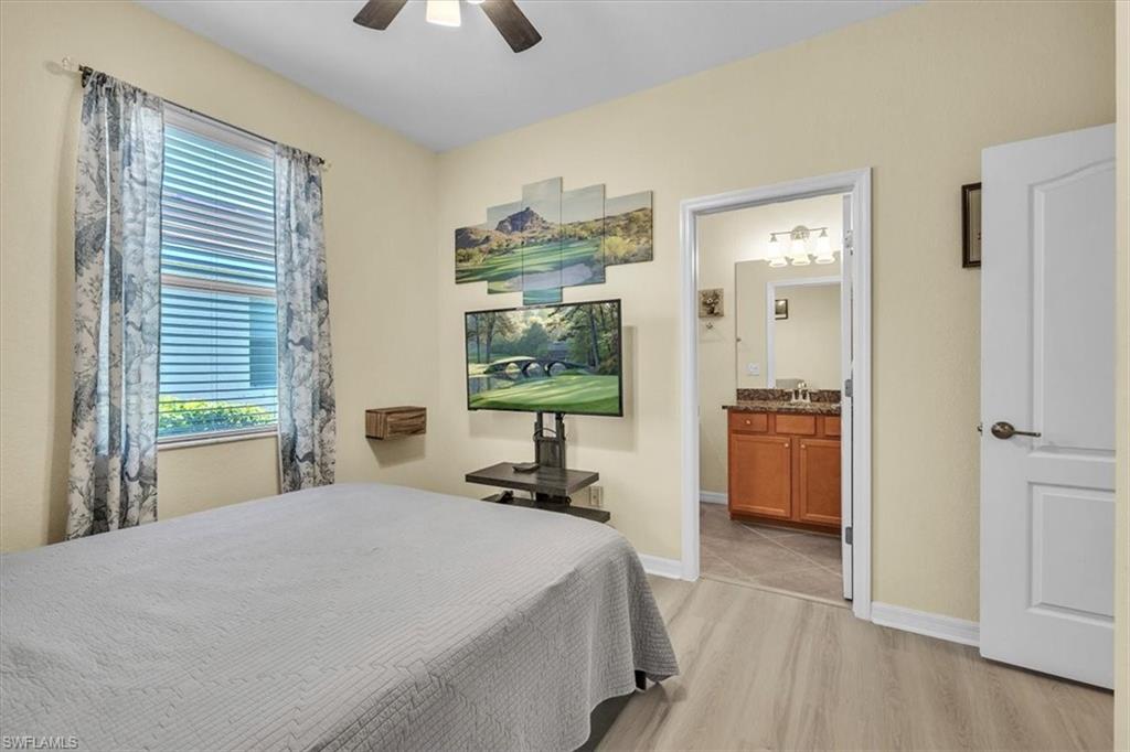 3112 Walnut Grove Lane Alva, FL 33920 - Photo 24 of 50 a bedroom with a bed and a chandelier