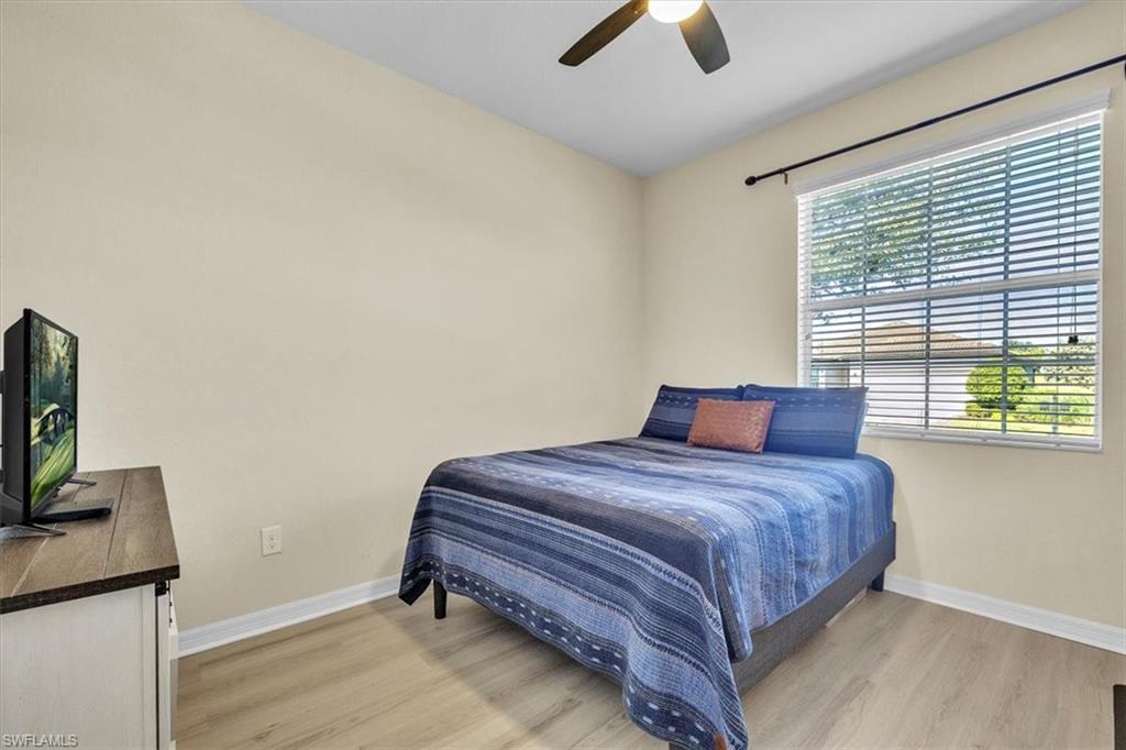 3112 Walnut Grove Lane Alva, FL 33920 - Photo 30 of 50 a bedroom with a bed and a flat screen tv