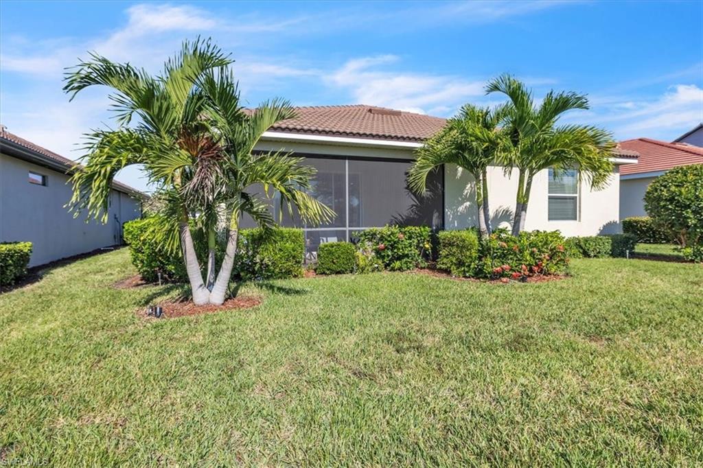 3112 Walnut Grove Lane Alva, FL 33920 - Photo 35 of 50 a front view of a house with a yard