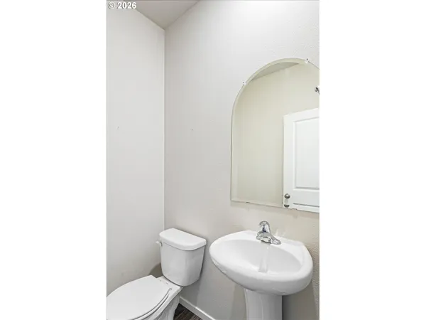 a bathroom with a sink toilet and mirror