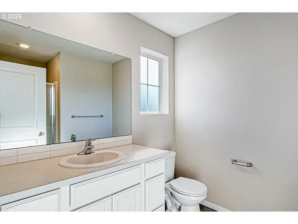 a bathroom with a sink toilet and a mirror