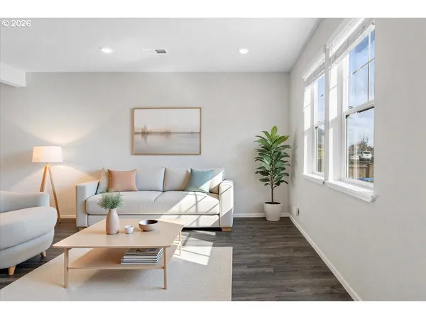 a living room with furniture and a painting on the wall
