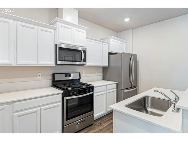 a kitchen with a sink stove and refrigerator