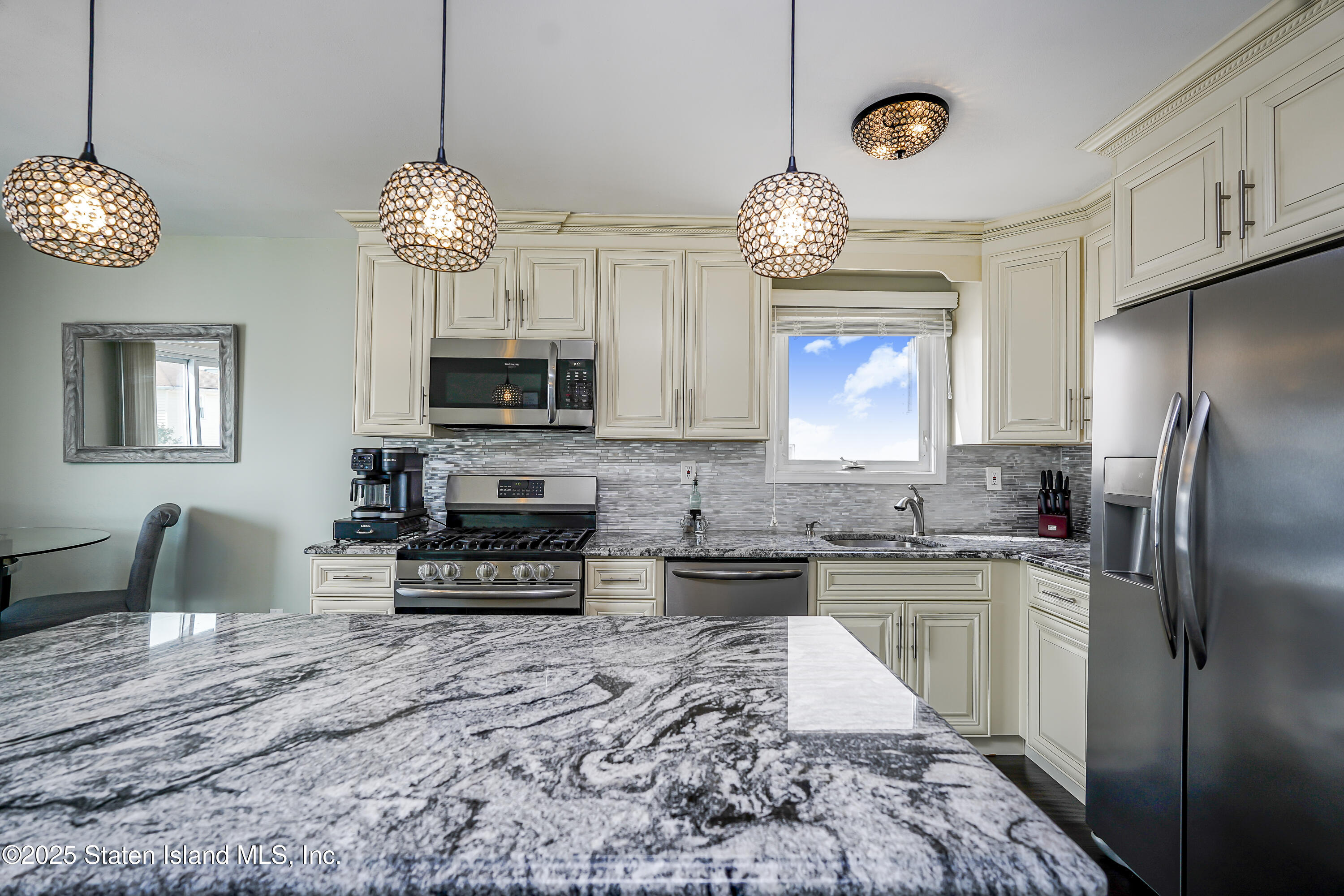 994 Rensselaer Avenue Staten Island, NY 10309 - Photo 11 of 34 a kitchen with stainless steel appliances granite countertop a stove refrigerator and a microwave oven