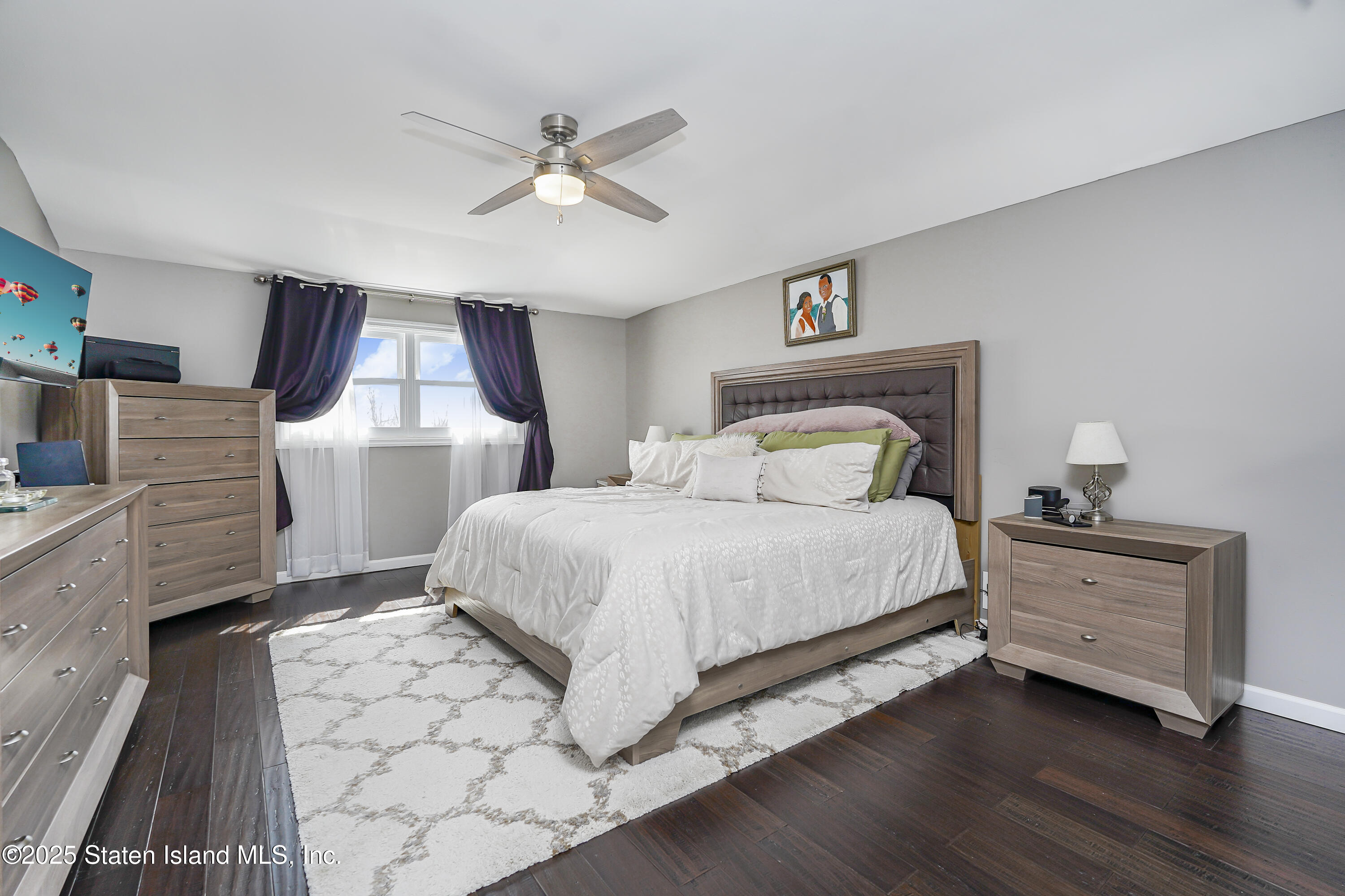 994 Rensselaer Avenue Staten Island, NY 10309 - Photo 15 of 34 a bedroom with a bed and a chandelier