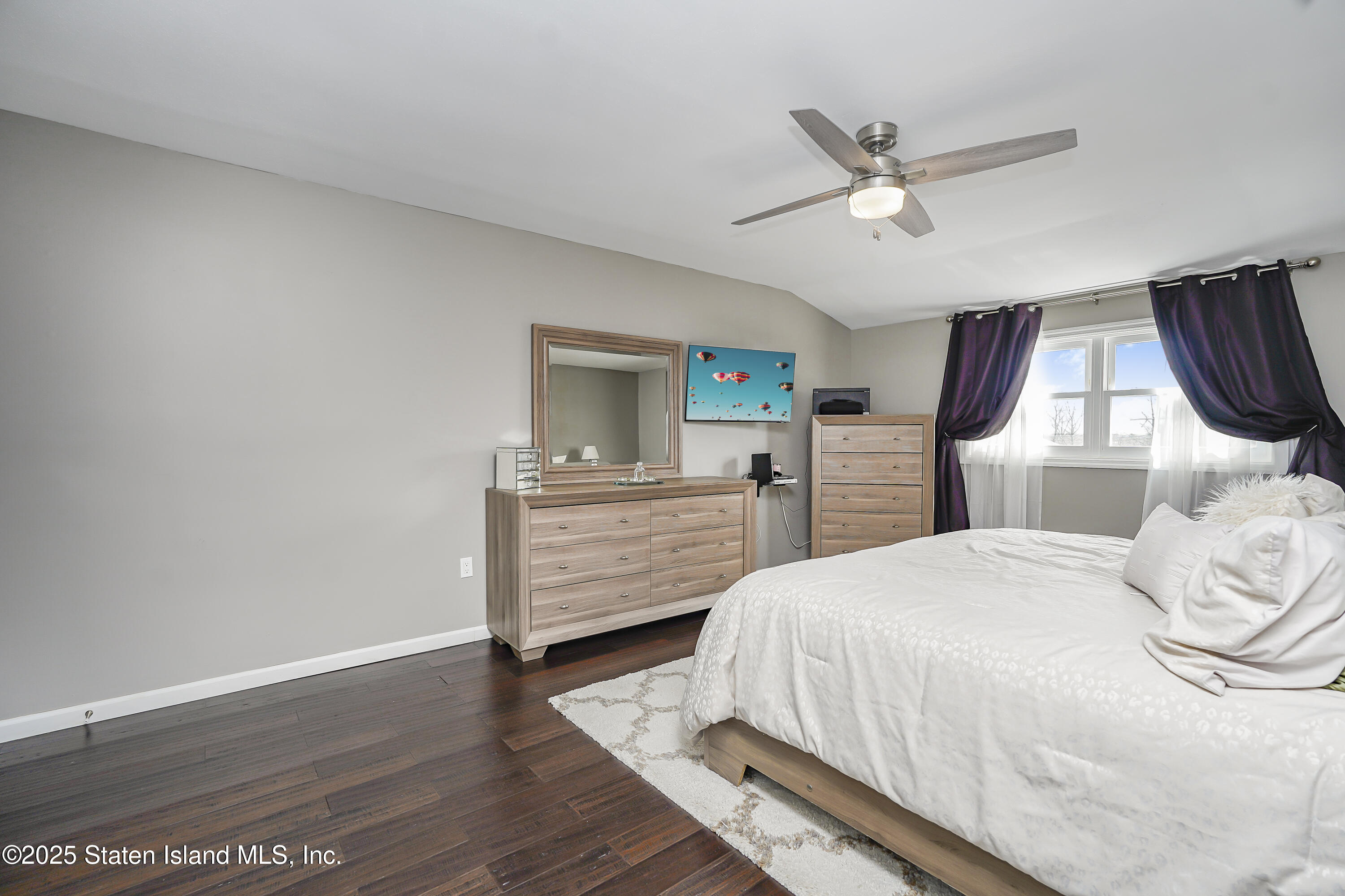 994 Rensselaer Avenue Staten Island, NY 10309 - Photo 16 of 34 a bedroom with a bed and a chandelier