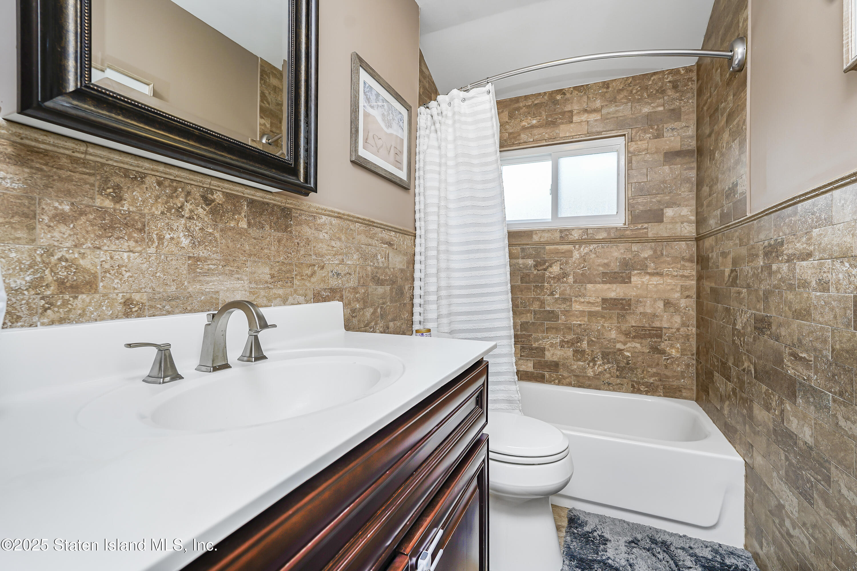 994 Rensselaer Avenue Staten Island, NY 10309 - Photo 22 of 34 a bathroom with a sink a toilet and shower