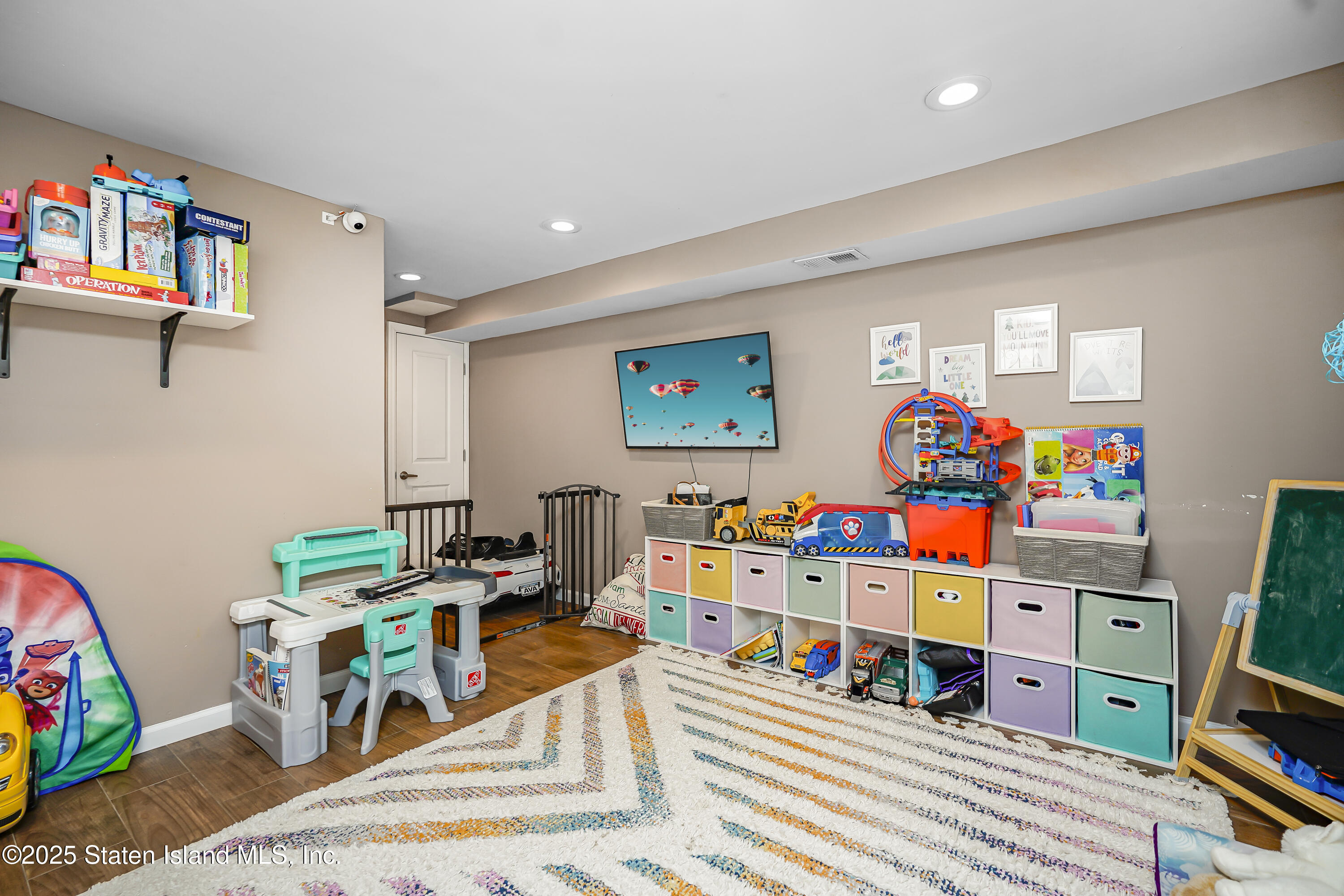 994 Rensselaer Avenue Staten Island, NY 10309 - Photo 29 of 34 a room with furniture a baby crib and a couch